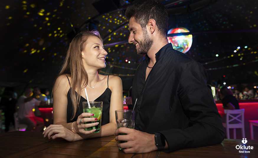 Man and woman sharing a cocktail